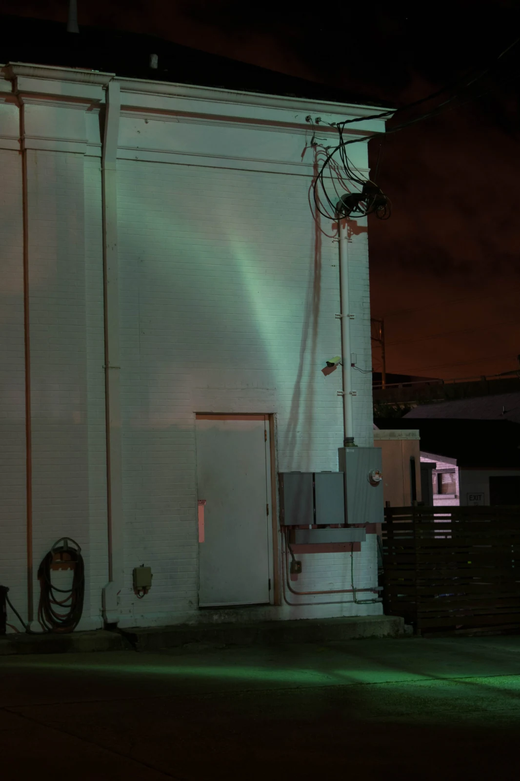 A green-lit industrial doorway